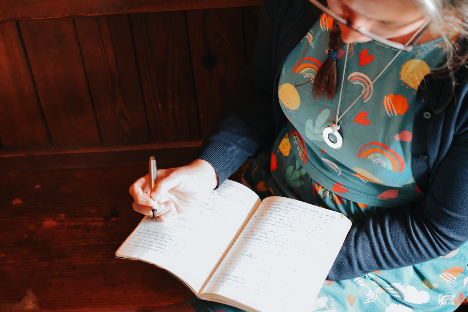 Birth Preparation teacher writes in a journal.